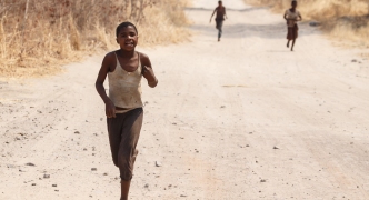 CHOBE, BOTSWANA - OCTOBER 5 2013: Poor African children wander through the desert like Chobe National Park. This year was declared as a drought year by the government in Botswana, Africa
