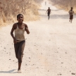 CHOBE, BOTSWANA - OCTOBER 5 2013: Poor African children wander through the desert like Chobe National Park. This year was declared as a drought year by the government in Botswana, Africa