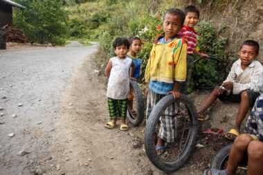 CHIN STATE, MYANMAR - JUNE 16 2015: Children play in the street of a village in the recently opened to foreigners area of Chin State - western Myanmar (Burma)