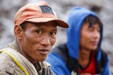 FALAM, MYANMAR - JUNE 17 2015: Local men sitting at the start of the monsoon season in the recently opened to tourists Chin State region of Western Myanmar (Burma)