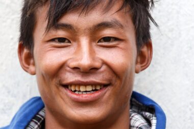 FALAM, MYANMAR - JUNE 17 2015: Local boy smiling at the start of the monsoon season in the recently opened to tourists Chin State region of Western Myanmar (Burma)