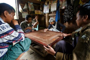HAKHA, MYANMAR - JUNE 19 2015: Local men play Carrom's in the Hakha region in Chin State, Myanmar.