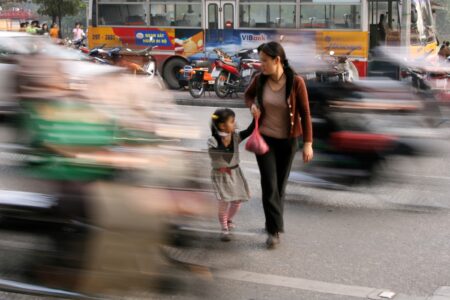 People Crossing Street in the Busy Streets of Hanoi, Vietnam